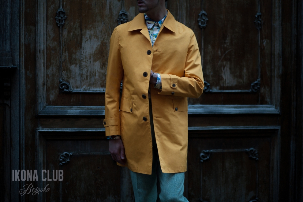 Fashion dress code. Street photography. Stars wear: yellow coat, fish print shirt, green pants.